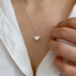 Elegant 925 sterling silver heart pendant necklace with white shell inlay on female model