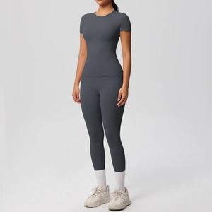 Detail of high-waist dark grey yoga leggings with functional side pockets and matte finish