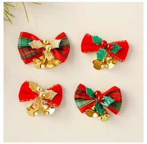 Detail of red Christmas bows with small metal bells, green plaid, and golden leaves