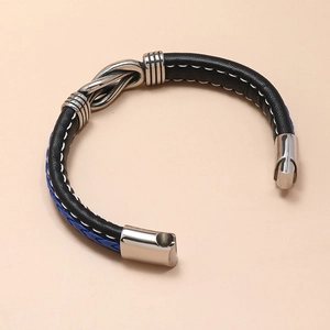 Detail of blue and black woven leather bracelet with silver magnetic clasp and stitching