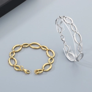 Detail of oval link chains in gold and silver finish with secure lobster clasps