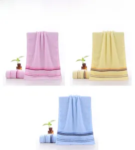 Vertical stack showing pink, yellow, and blue cotton towels with striped texture details
