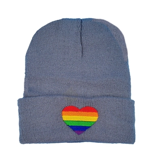 Blue-grey knit beanie with a colorful rainbow heart embroidery on the folded cuff