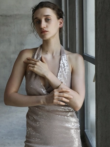Detail of slim fit halter neck dress in champagne gold with sparkling high-density sequins