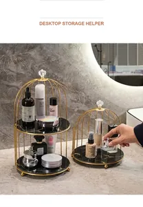 Modern gold birdcage vanity rack with marble base on a bathroom counter