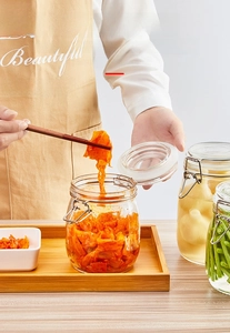 Close-up of airtight glass storage jars with stainless steel buckles for food preservation