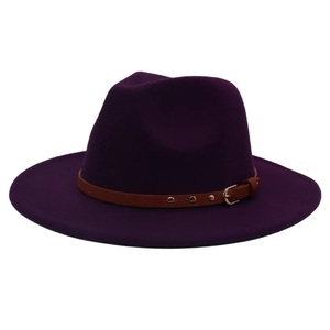 Detail of dark purple wool fedora hat with brown leather band and gold metal rivets