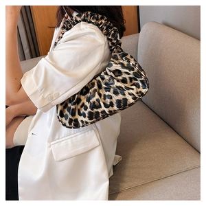 Detailed view of leopard print cloud bag with pleated texture and stylish shoulder strap