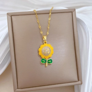 Detailed view of sunflower pendant with yellow enamel and crystals on a gold chain