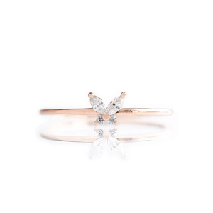 Detailed macro view of butterfly shaped colorful zircon stones set in a rose gold ring