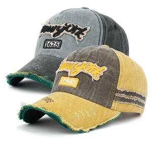 Detail of distressed baseball cap featuring vintage New York embroidery and frayed brim