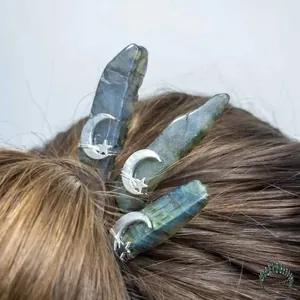 Detailed view of three handmade moon and star hairpins with raw labradorite crystals