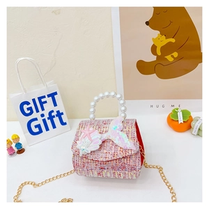 Detail of pink tweed girl's handbag with sequin mermaid tail and pearl handle