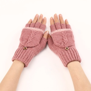 Dettaglio guanti in maglia a trecce rosa con bordo in pelliccia e bottone in legno