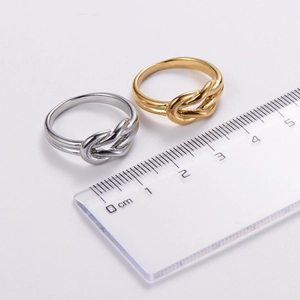Bowtie cutout irregular rings in gold and silver finish shown with size measurements