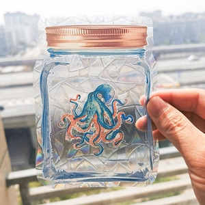 Macro shot of a holographic octopus glass jar sticker with vibrant rainbow reflections