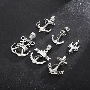 Macro view of six silver stainless steel nautical skull anchors and skipper pendants