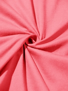 Close-up of soft coral pink cotton knit fabric showing fine texture and breathable weave