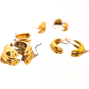 Elegant gold-tone wave textured curved stud earrings in minimalist stainless steel