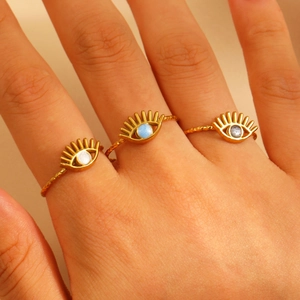 Three-piece gold-tone evil eye rings set with white, blue and grey enamel eye motifs