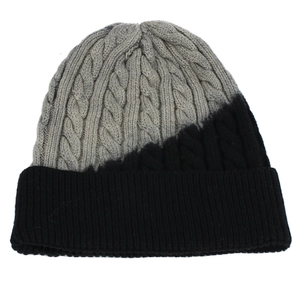 Dettaglio del cappello invernale in maglia a trecce con design bicolore grigio e nero