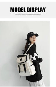 Side view of beige and black canvas backpack showing flap design and double front pockets