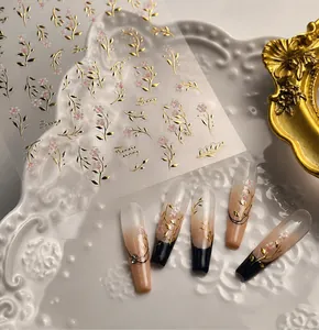 High-quality golden leaf and floral nail art stickers shown with elegant press-on nails