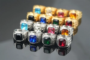 Macro view of vintage dragon rings featuring square colorful gemstones and polished metal