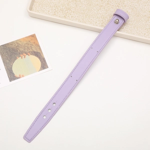 Close-up of purple leather wrist strap with metal rivets and adjustable holes detail