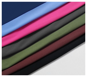 Close-up of multicolored elastic yoga pants showing soft brushed fabric texture in seven colors