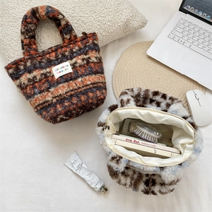 Detail of plush tote bags with wavy and spotted patterns showing spacious zipper interior