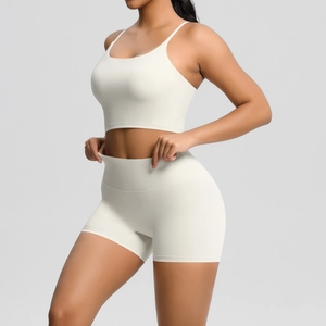 Side view of cream white high-waisted yoga set featuring thin strap bra and sports shorts
