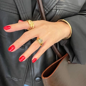 Chic gold-plated stacking rings and cuff bracelet styled with a dark leather jacket