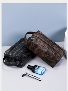 Close-up of vintage PU leather toiletry bags with double zippers and side handle