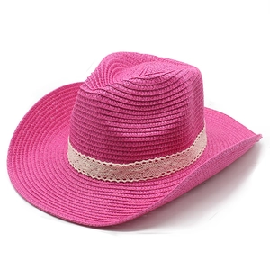 Close-up of magenta woven straw cowboy hat featuring an elegant white lace band detail