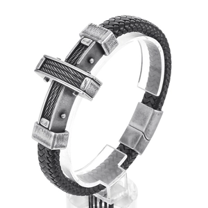 Mens woven leather bracelet with steel cross pendant and magnetic clasp on white background