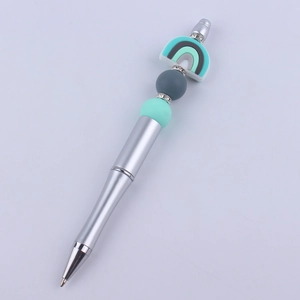 Detail of DIY beadable pen with silver metal body, grey silicone beads and rainbow decor