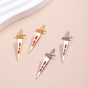 Detailed view of gothic sword stud earrings with red oil blood drip effects in gold and silver