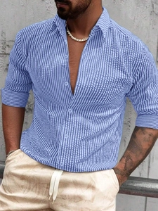 Close-up of men's slim-fit long-sleeve shirt featuring blue and white vertical stripes