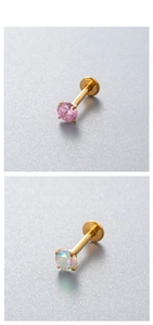 Detail of titanium labret studs with pink zircon and opal in gold-tone finish