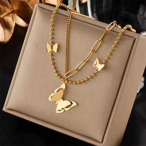 Elegant double-layered butterfly necklace in gold stainless steel on jewelry box