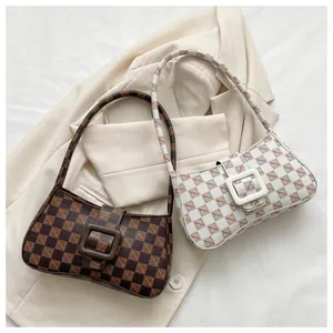 Detail shot of two vintage baguette bags with monogram prints and large square buckles