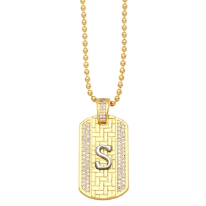 Detail of gold letter S dog tag pendant with sparkling zircons on a bead chain necklace