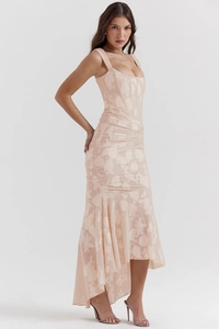 Detailed texture of light pink jacquard fabric on a strapless fishtail evening gown