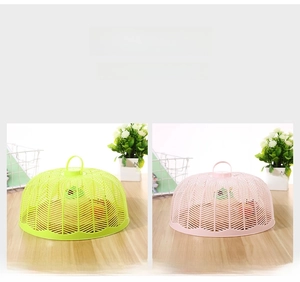 Detail of pink and lime green mesh food covers with convenient top handles for home use