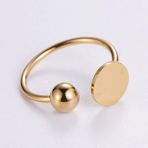Minimalist gold open ring featuring a spherical bead and a flat round metal plate detail
