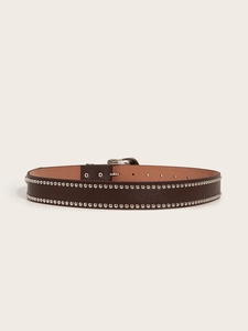 Close-up of brown leather punk belt with double rows of silver metal rivets