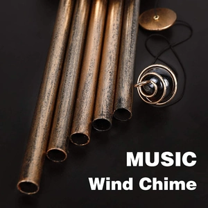 Macro view of vintage bronze metal tubes and wooden striker of the outdoor music wind chime
