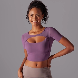 Detailed view of women's short-sleeve purple yoga top with front cutout design
