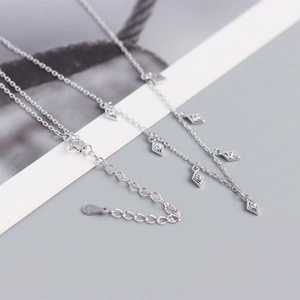 Detailed macro view of S925 silver fringe necklace with rhombic zircon pendants